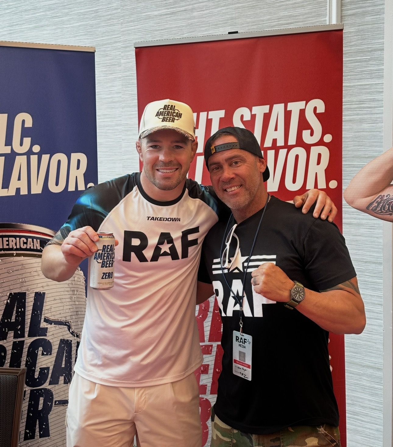 Black and white photograph of Anton Payne with a fighter at a media event